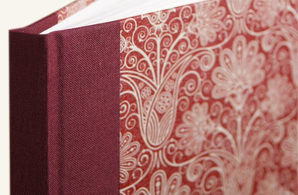 Linen-backed notebook with a hard cover, burgundy with floral Art Nouveau ornaments